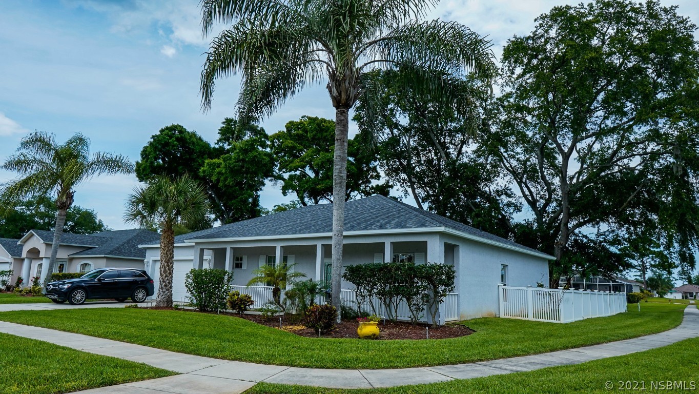 339 Mariners Gate Drive Edgewater, FL 32141 - Photo 5 of 30 a front view of a house with a garden