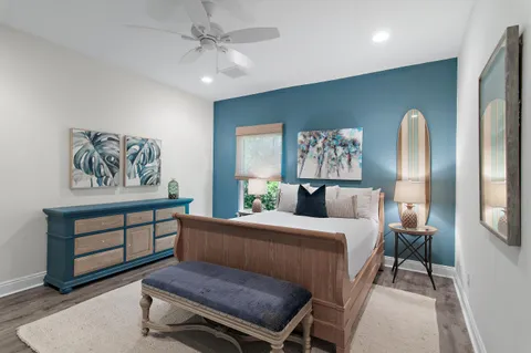 a bedroom with a bed and a painting on the wall