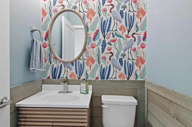 a bathroom with a sink a toilet and a mirror