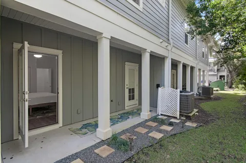 a view of a room that has a bed and a table and chair