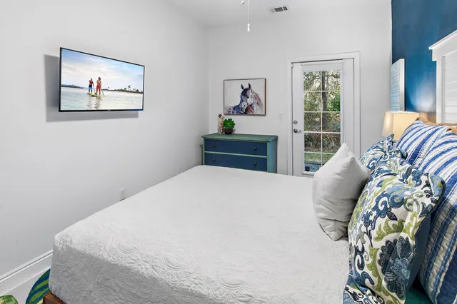 a bedroom with a bed and painting on the wall