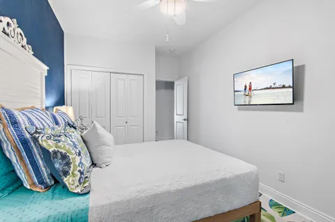 a bedroom with a bed and a painting on the wall