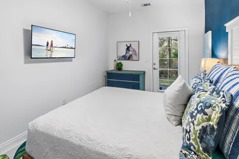 a bedroom with a bed and painting on the wall