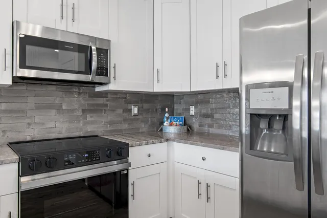 a kitchen with stainless steel appliances a stove a microwave and cabinets