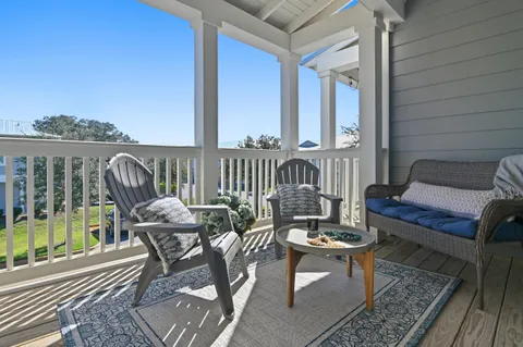 a balcony with furniture and a potted plant