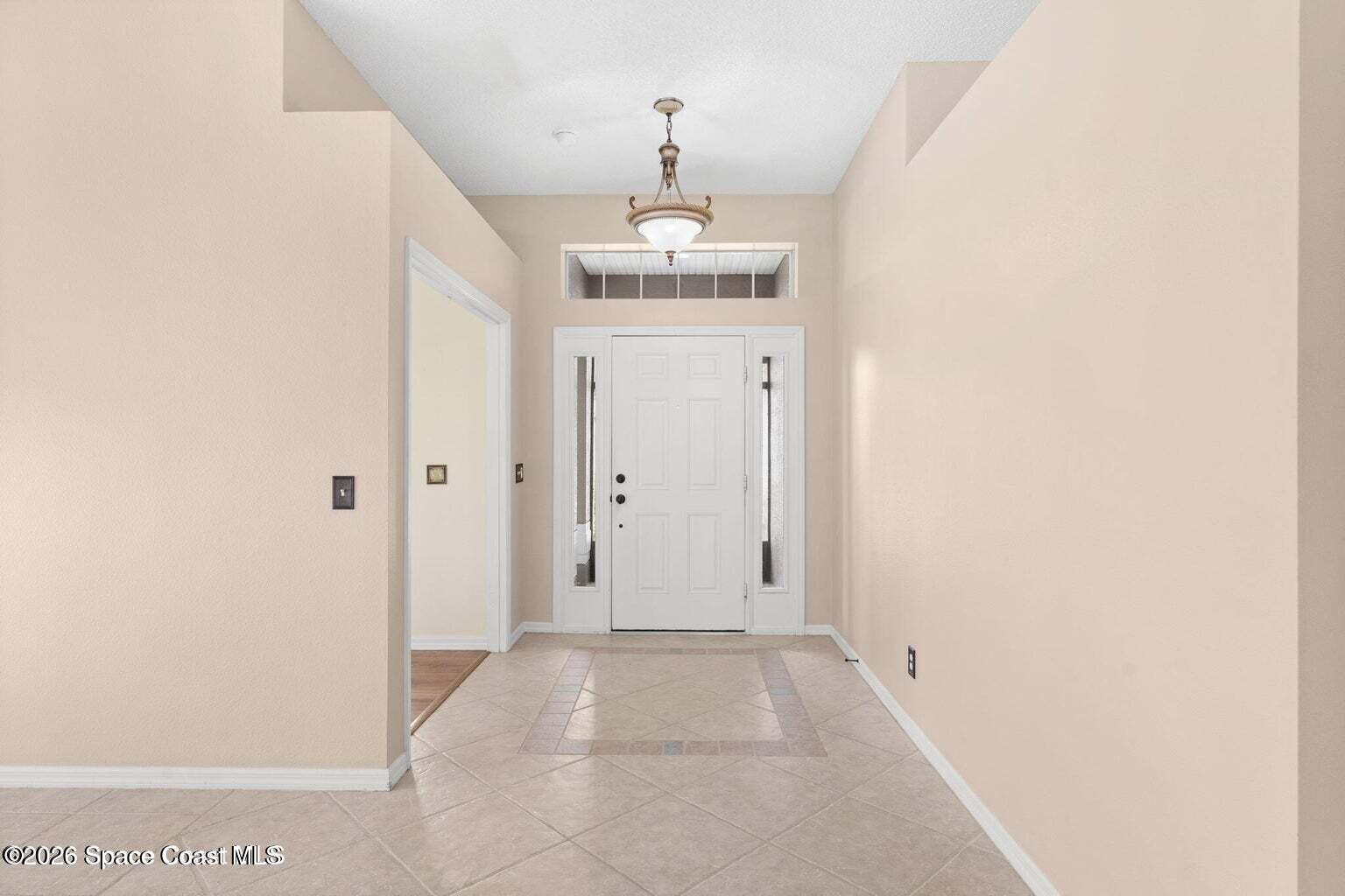 4741 Decatur Circle Melbourne, FL 32934 - Photo 4 of 44 a view of a hallway to a bedroom