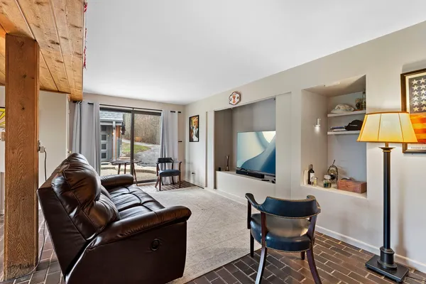 a living room with furniture and a floor to ceiling window