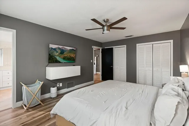 a bedroom with a bed and a chandelier