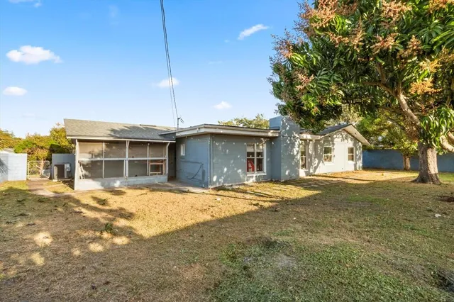a view of a house with a backyard