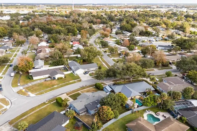 an aerial view of residential houses with city view