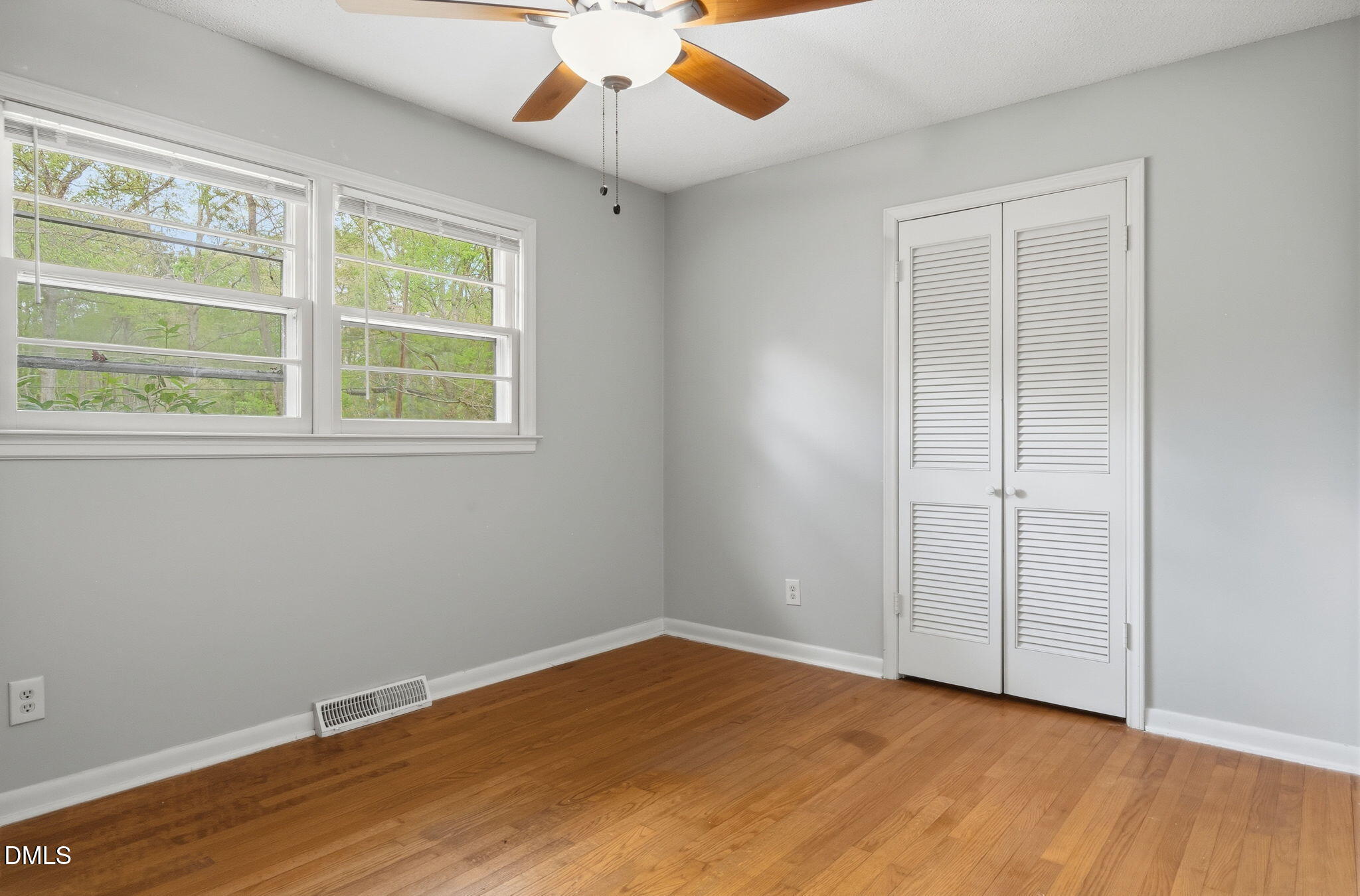 511 Hunter Street Durham, NC 27712 - Photo 16 of 30 an empty room with wooden floor cabinet and windows