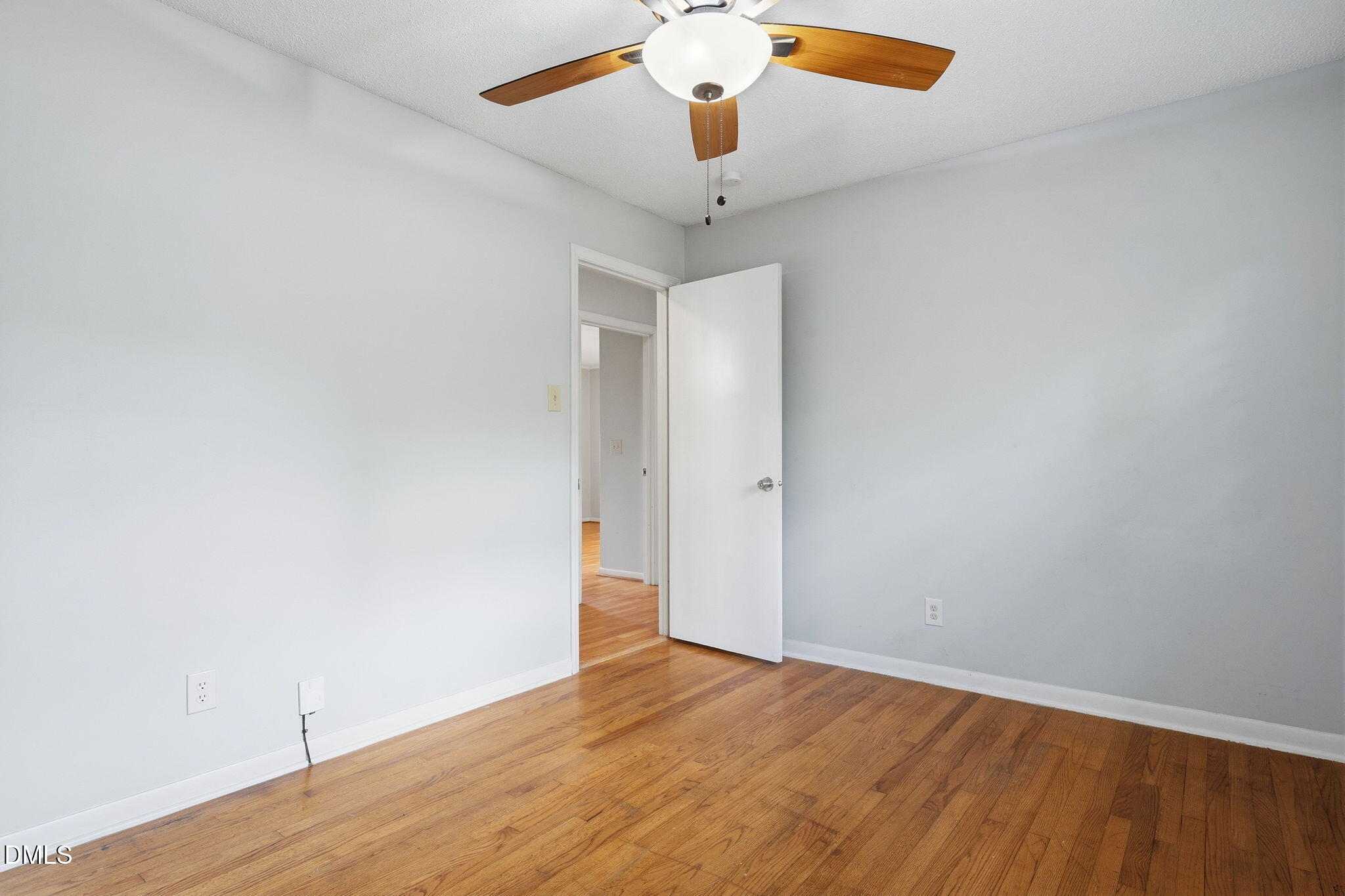 511 Hunter Street Durham, NC 27712 - Photo 17 of 30 an empty room with wooden floor and a ceiling fan
