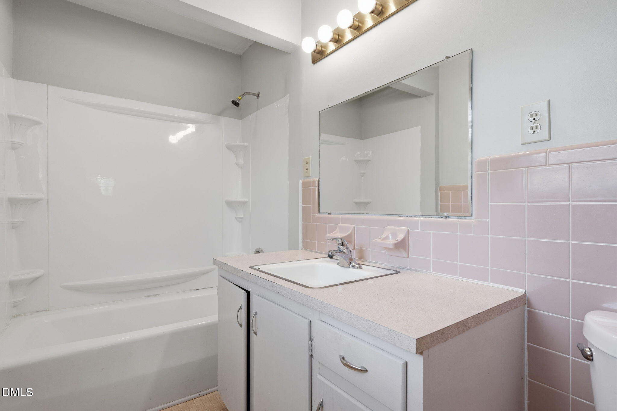 511 Hunter Street Durham, NC 27712 - Photo 20 of 30 a bathroom with a sink a vanity and a mirror