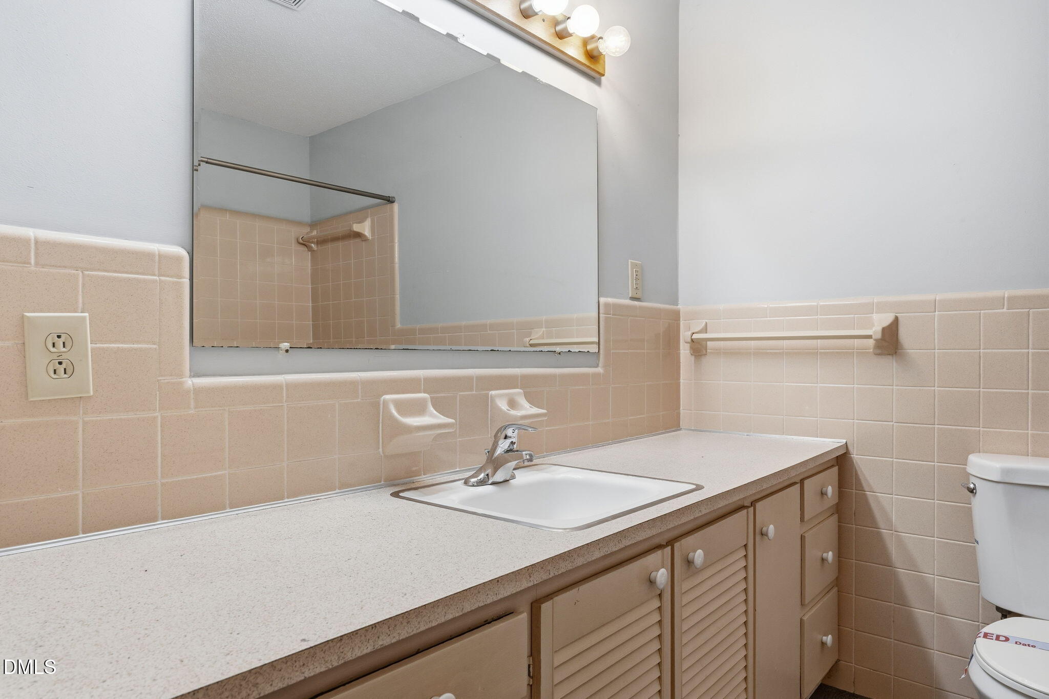 511 Hunter Street Durham, NC 27712 - Photo 22 of 30 a bathroom with a sink a toilet and mirror