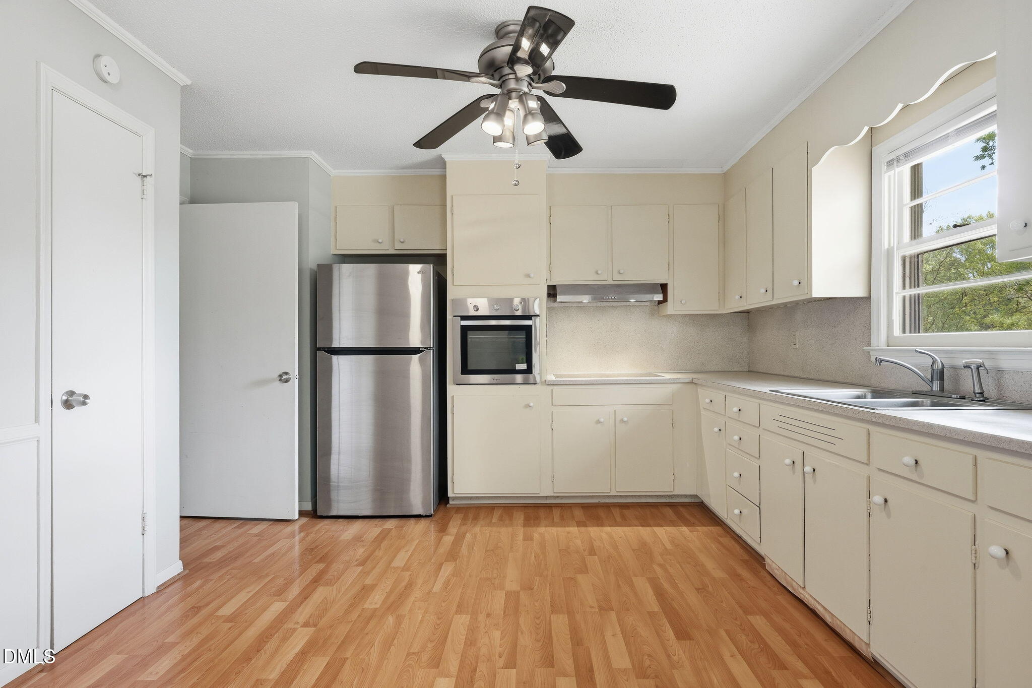 511 Hunter Street Durham, NC 27712 - Photo 5 of 30 a kitchen with a refrigerator and white cabinets