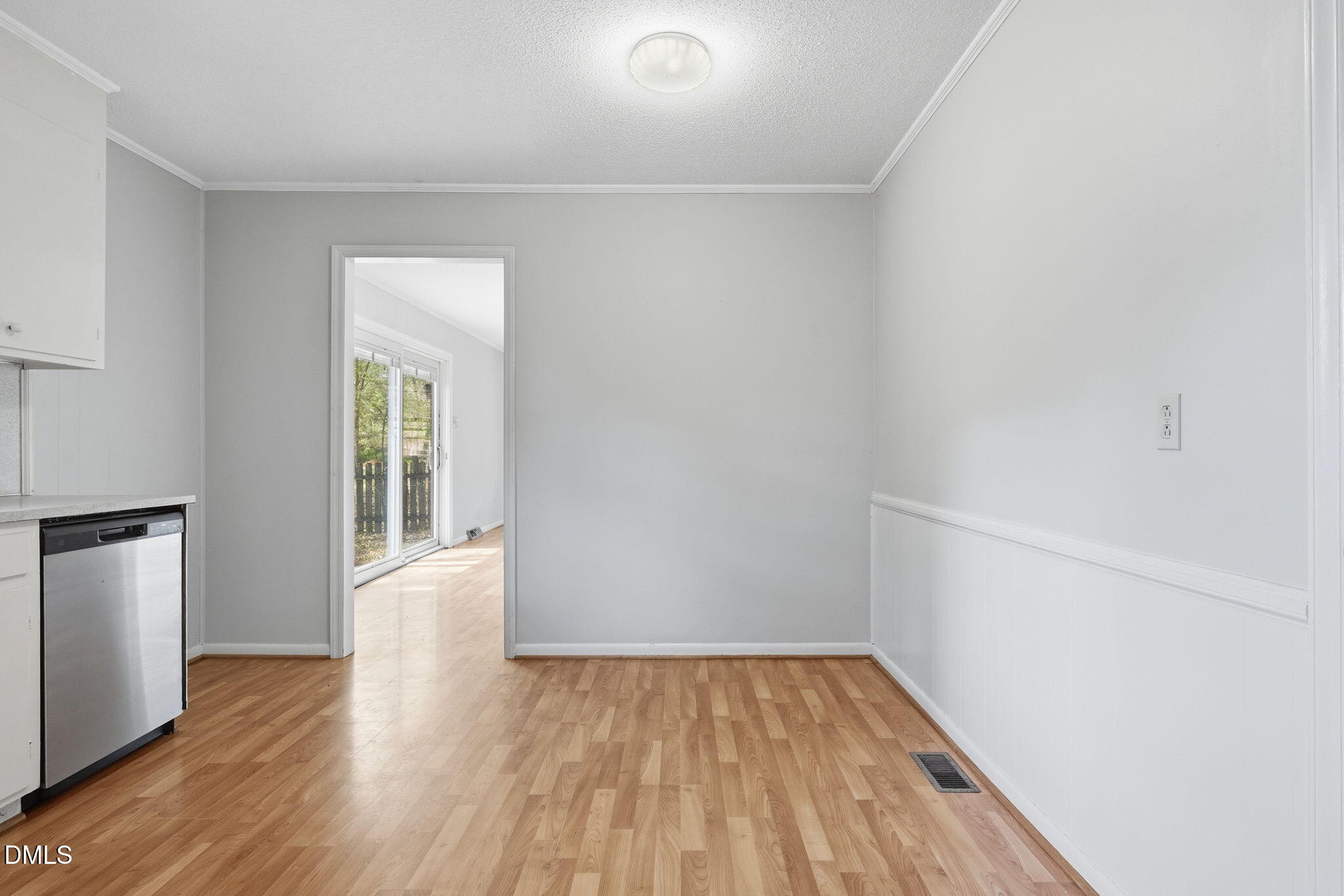 511 Hunter Street Durham, NC 27712 - Photo 7 of 30 a view of an empty room with wooden floor and a window