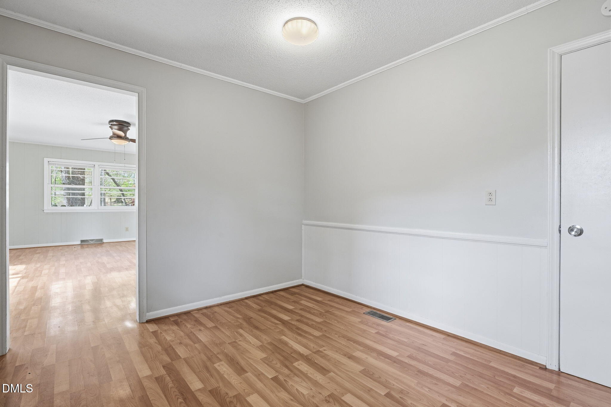 511 Hunter Street Durham, NC 27712 - Photo 10 of 30 a view of an empty room with wooden floor and a window