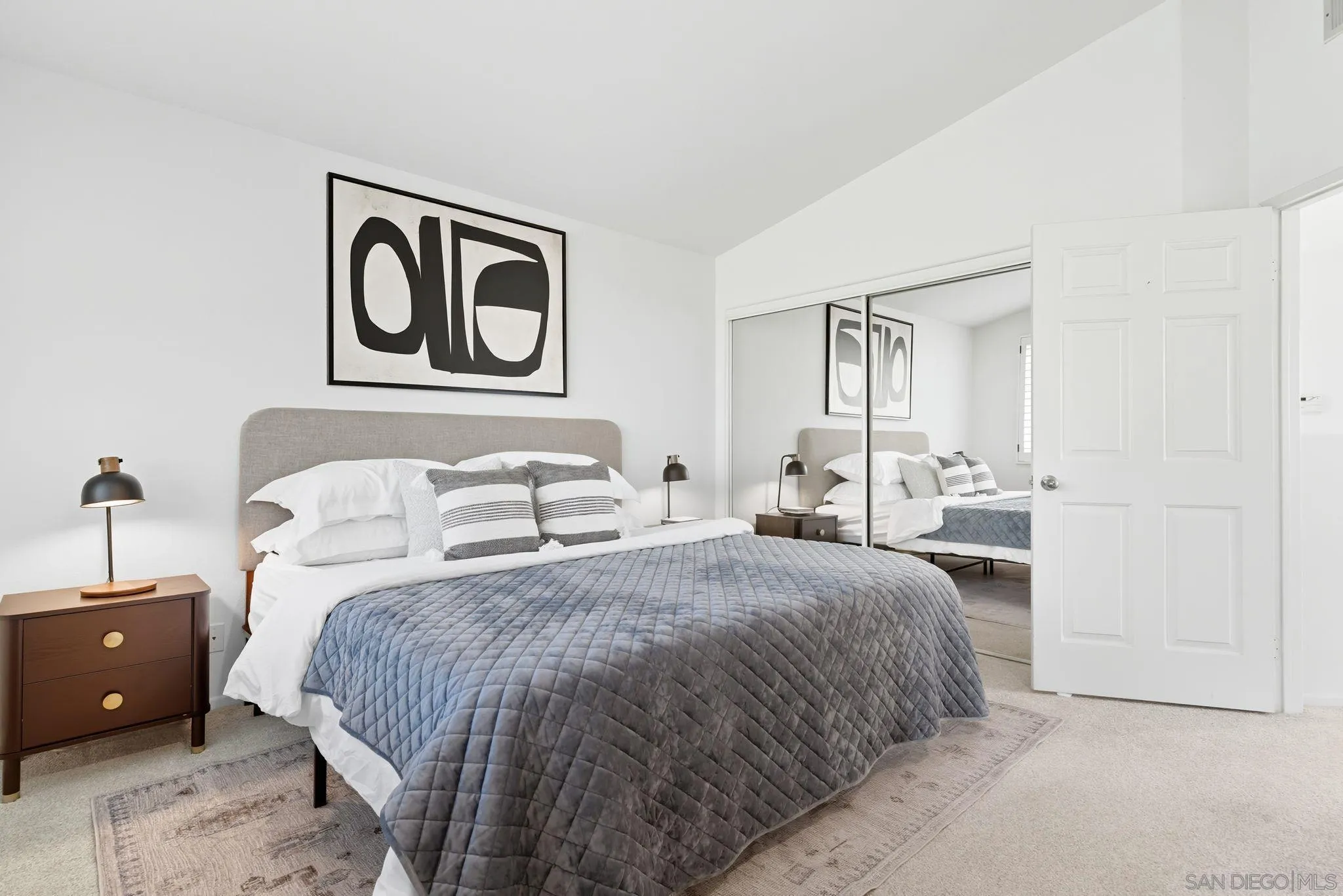 1802 Key Largo Road Vista, CA 92081 - Photo 12 of 24 a spacious bedroom with a bed and a lamp