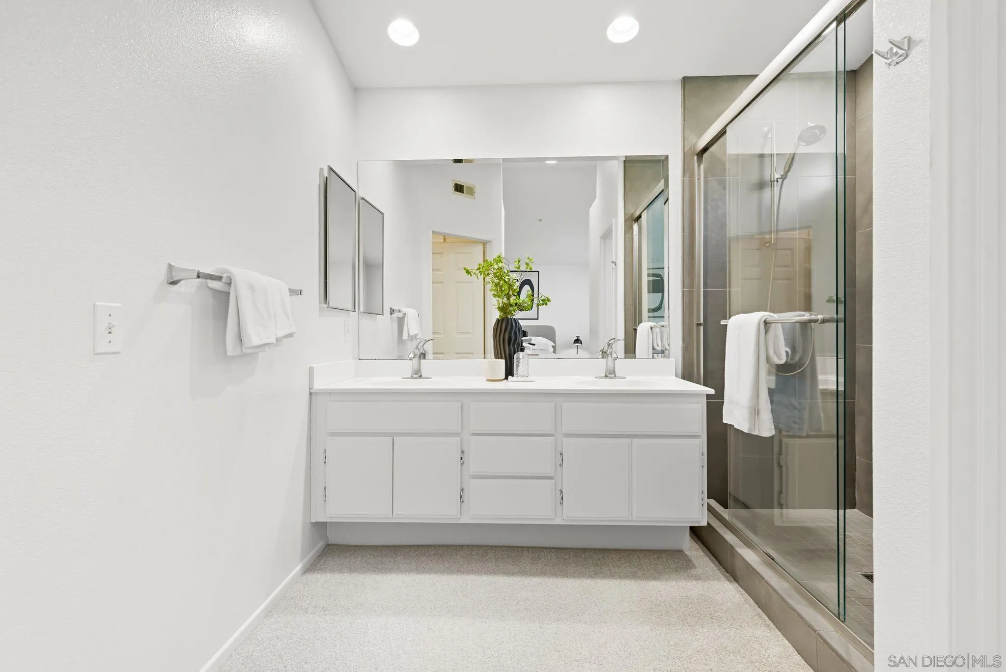 1802 Key Largo Road Vista, CA 92081 - Photo 13 of 24 a bathroom with a double vanity sink mirror and shower