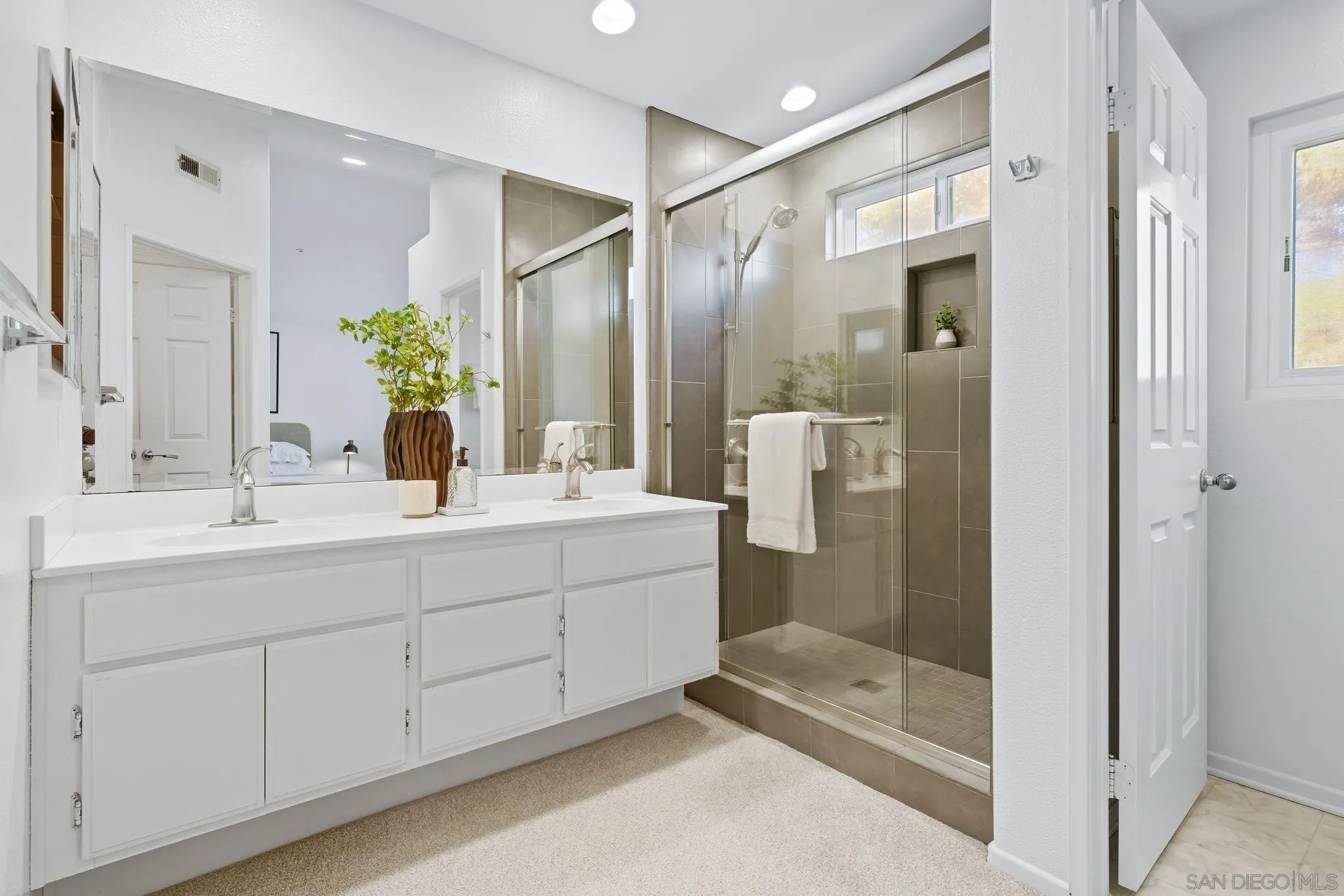 1802 Key Largo Road Vista, CA 92081 - Photo 14 of 24 a bathroom with a double vanity sink and mirror