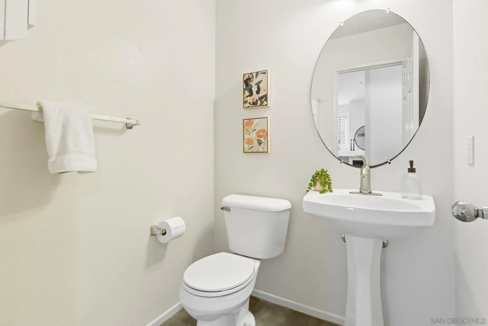 1802 Key Largo Road Vista, CA 92081 - Photo 16 of 24 a bathroom with a toilet a sink and mirror