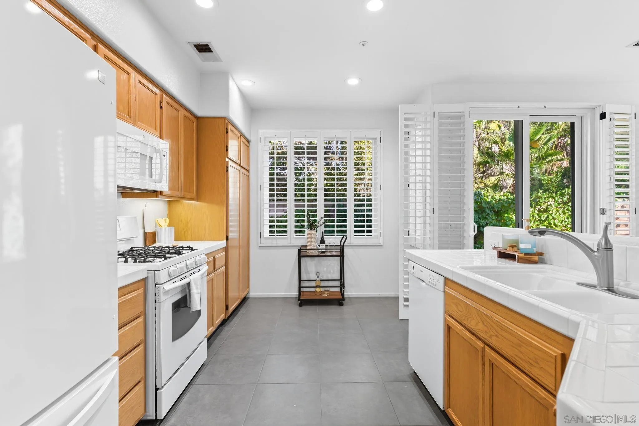 1802 Key Largo Road Vista, CA 92081 - Photo 6 of 24 a kitchen with a stove a sink and a refrigerator