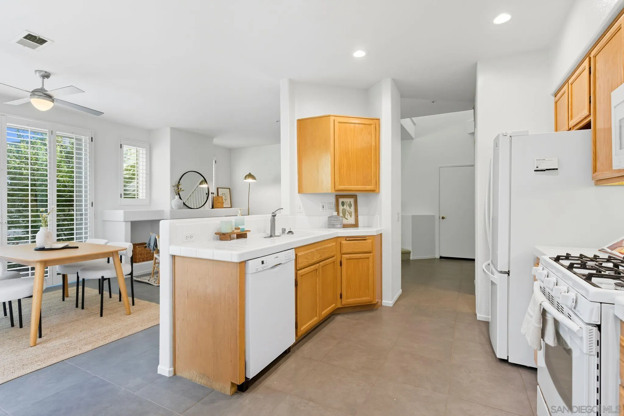 1802 Key Largo Road Vista, CA 92081 - Photo 7 of 24 a kitchen that has a lot of cabinets in it and a window