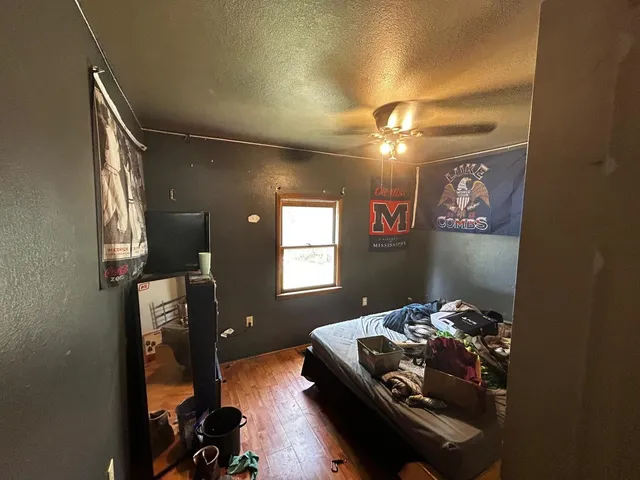 a bedroom with a bed and a chandelier