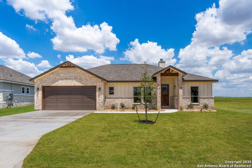 720 North Dickson Street Poth, TX 78147 - Photo 1 of 1 a front view of a house with garden