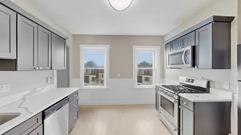 a kitchen with stainless steel appliances a stove a sink and a microwave