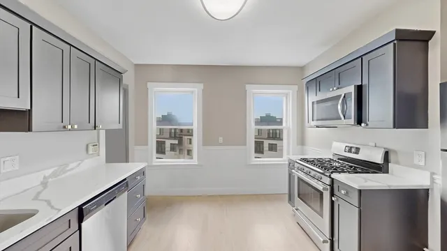 a kitchen with stainless steel appliances a stove a sink and a microwave