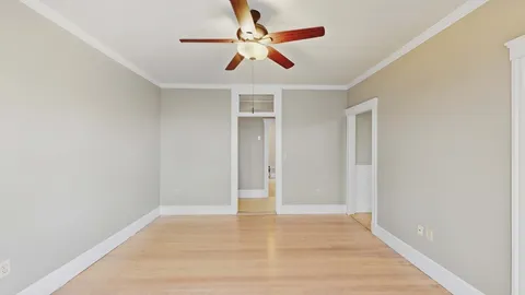an empty room with wooden floor and closet