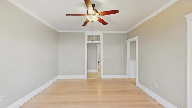 an empty room with wooden floor and closet