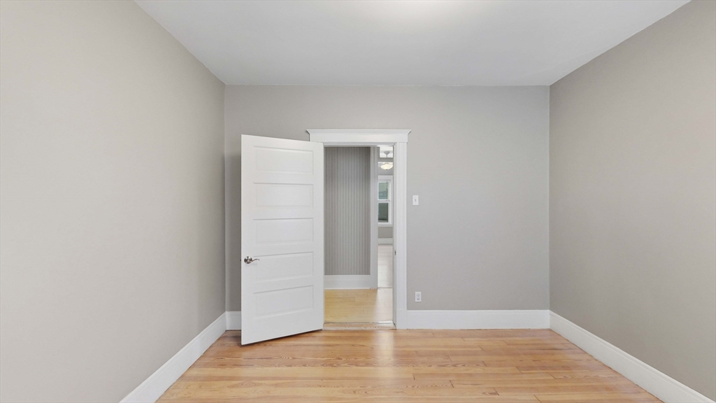 1 Orient Avenue, Unit 3C Boston, MA 02128 - Photo 17 of 25 an empty room with wooden floor and closet