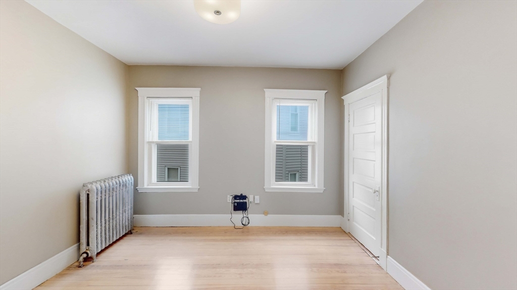 1 Orient Avenue, Unit 3C Boston, MA 02128 - Photo 19 of 25 an empty room with windows