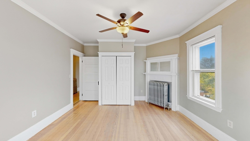 1 Orient Avenue, Unit 3C Boston, MA 02128 - Photo 20 of 25 a view of an empty room with chandelier fan and wooden floor