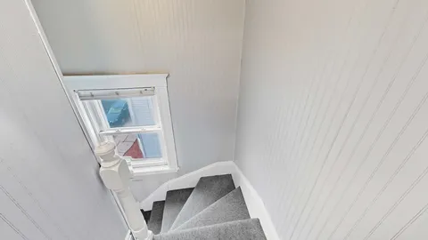 a view of a city street with tall buildings