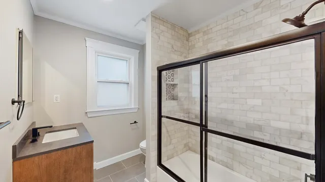 a bathroom with a toilet and a shower