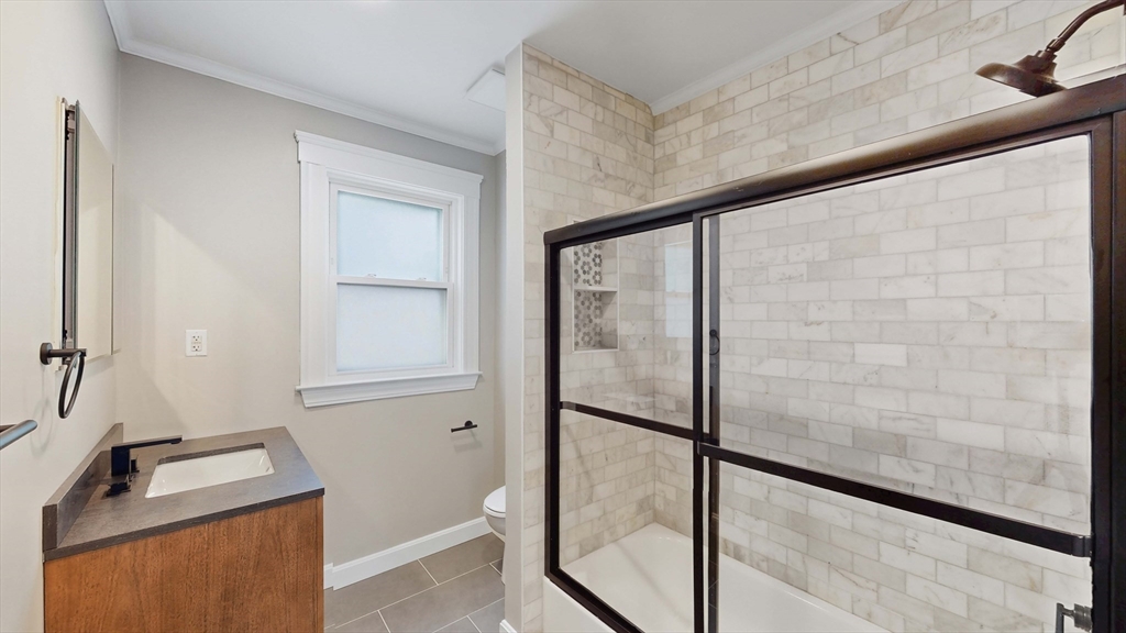 1 Orient Avenue, Unit 3C Boston, MA 02128 - Photo 7 of 25 a bathroom with a granite countertop sink mirror and a shower