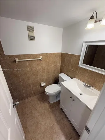 a bathroom with a shower and a sink