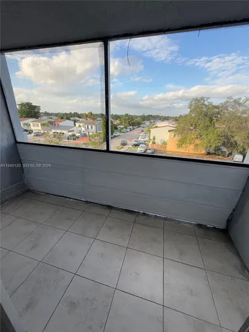 a view of balcony with wooden floor