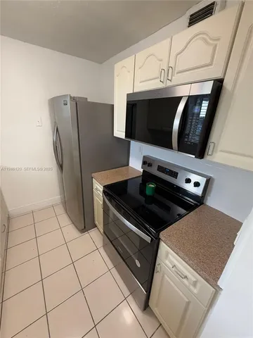a kitchen with white cabinets and a sink