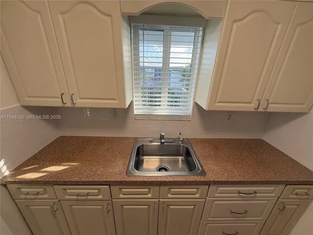 a kitchen with granite countertop cabinets and sink