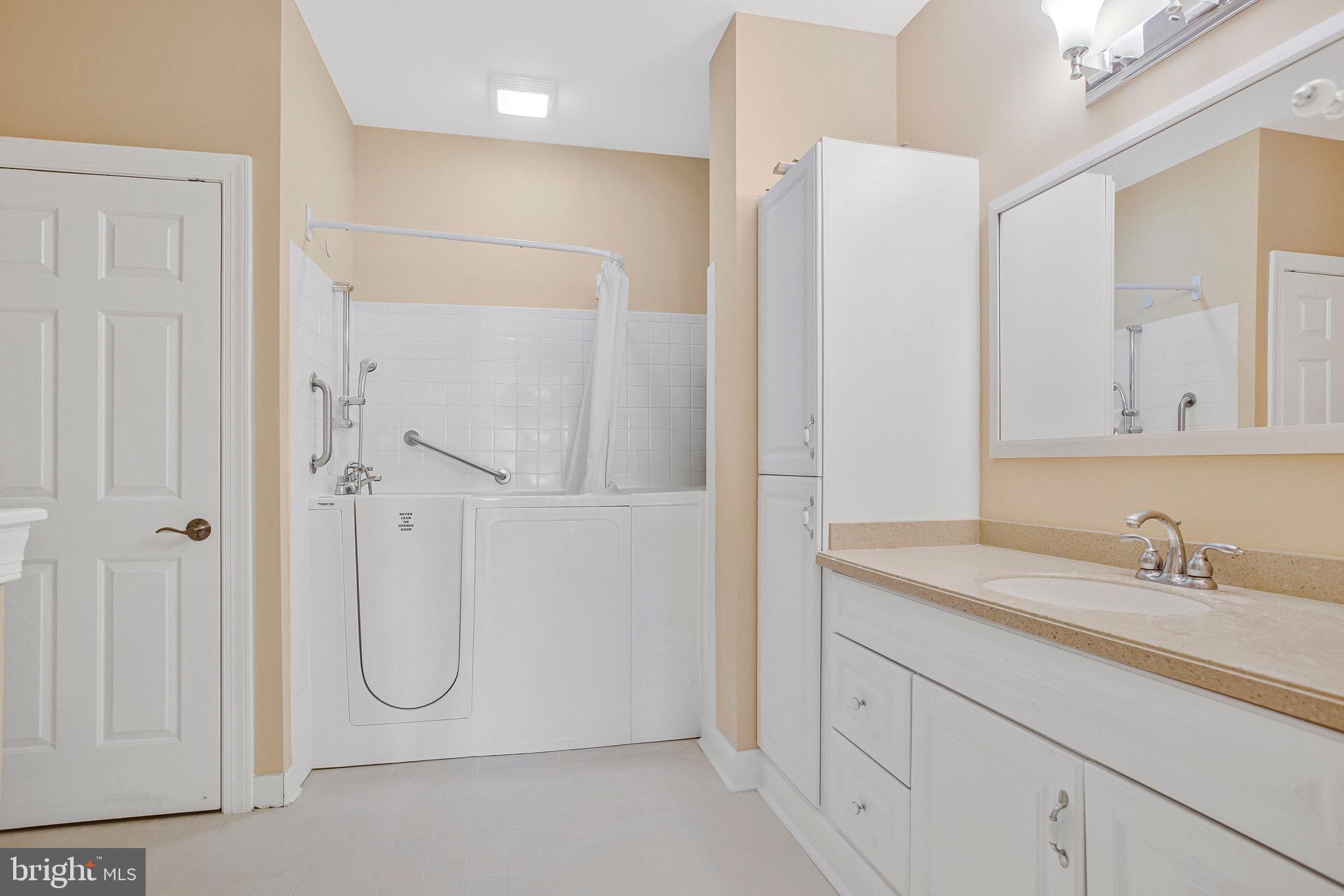 322 Hamlet Circle Edgewater, MD 21037 - Photo 12 of 21 a bathroom with a shower sink and mirror