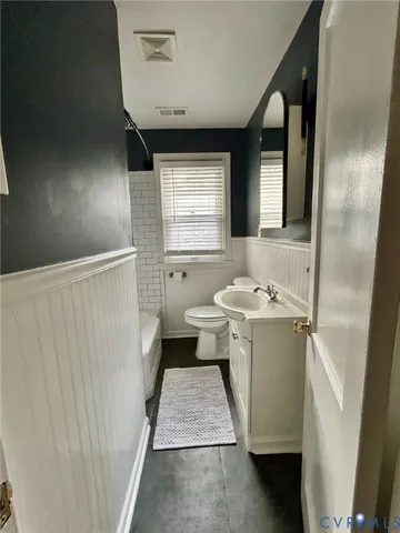 a bathroom with a sink toilet and mirror