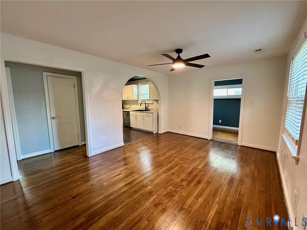 910 Forest View Drive Richmond, VA 23225 - Photo 7 of 23 an empty room with wooden floor chandelier fan and windows
