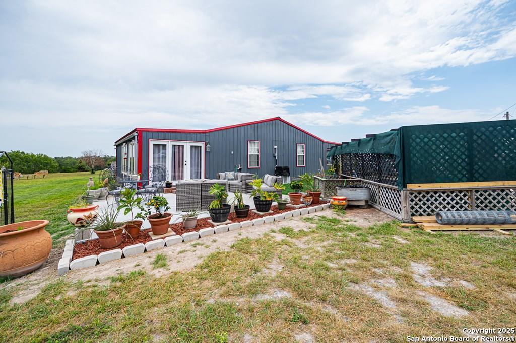 a view of a house with backyard porch and garden
