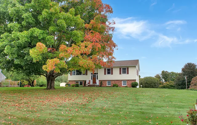 a front view of a house with a garden