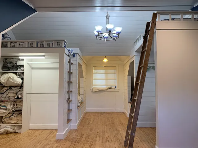 a view of kitchen and hallway with wooden floor