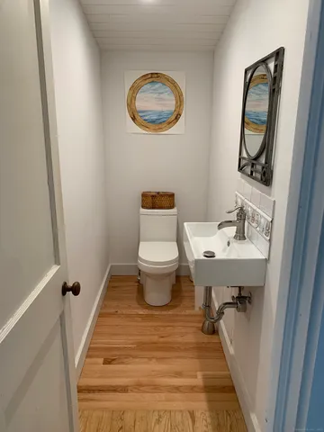 a bathroom with a sink toilet and a mirror
